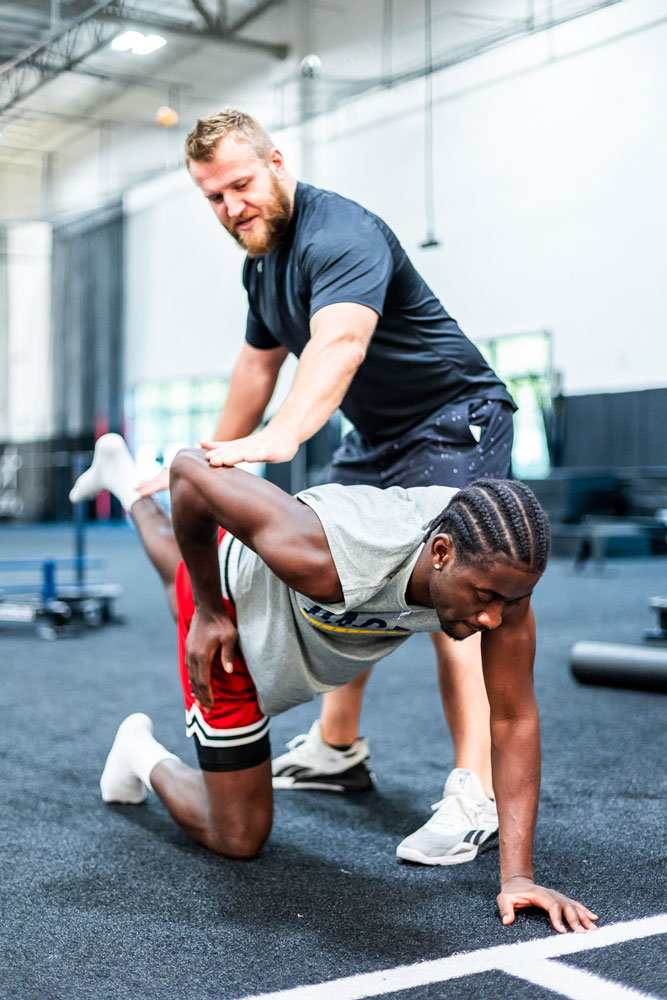 Coach Taylor having fun with his clients in the gym